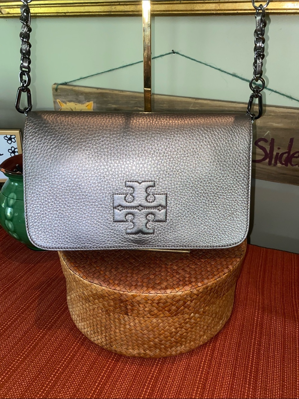 Tory Burch Thea Crossbody Bag crafted in metallic silver pebbled leather